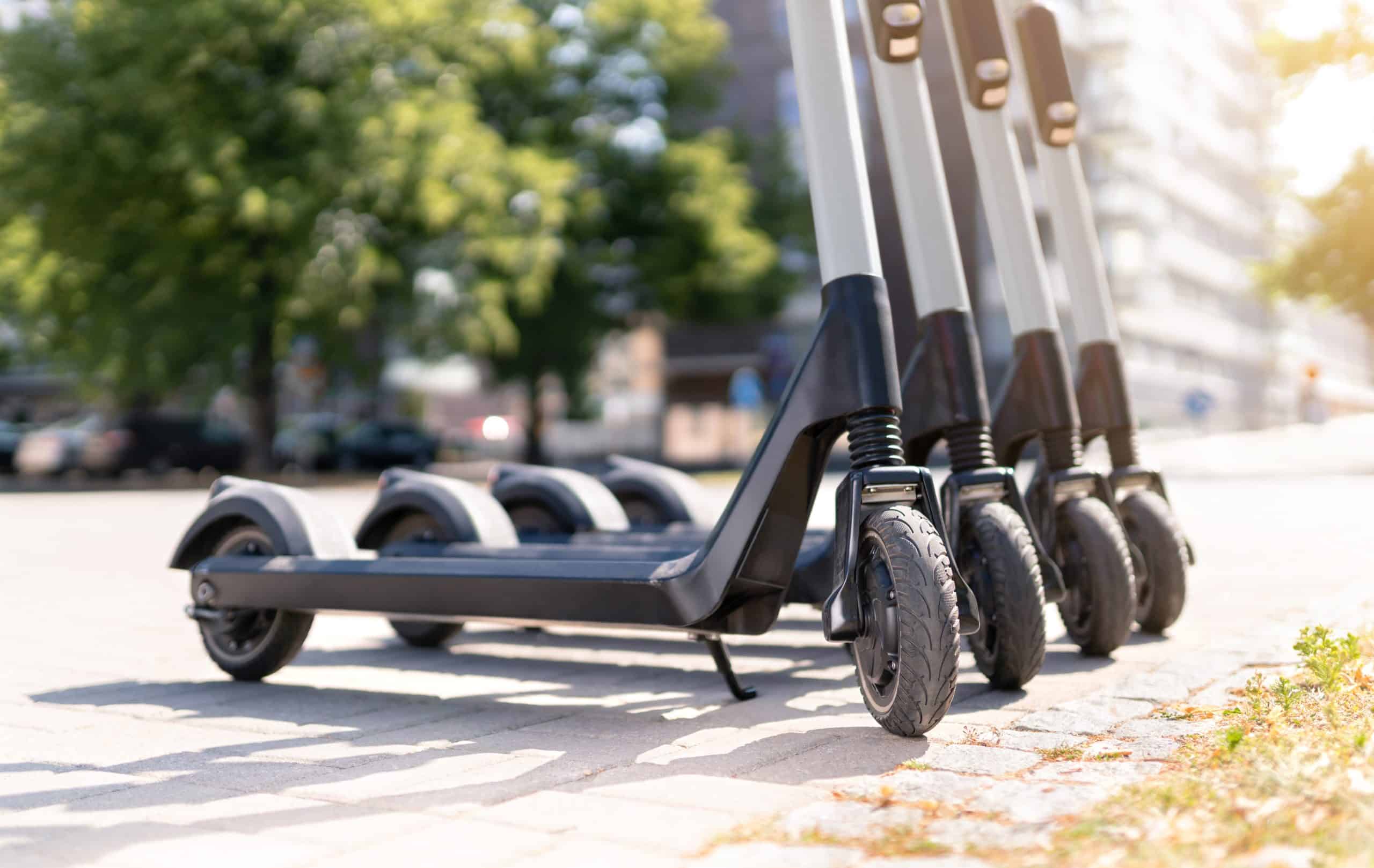 Electric kick scooters in city. E vehicle for rent. Urban modern transportation and technology concept.